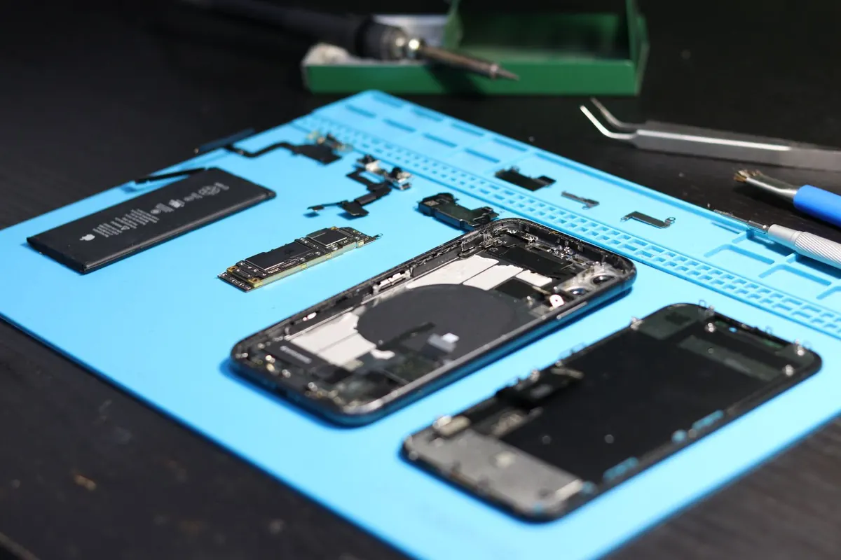 Celular desarmado sobre tapete de trabajo